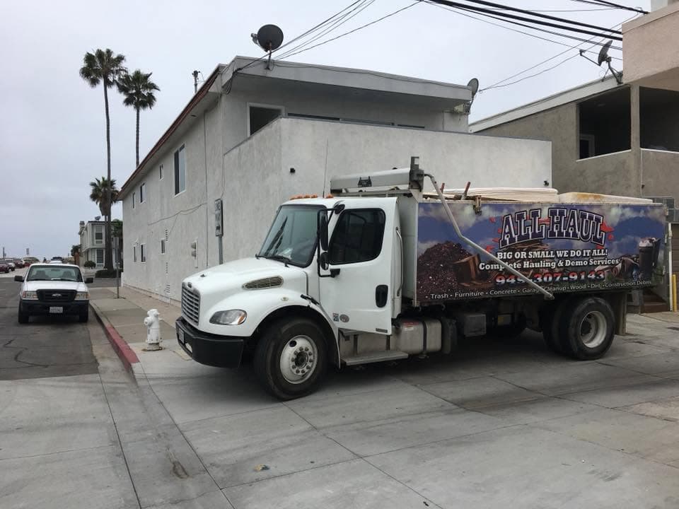 All Haul truck parked on a residential street near the coast
