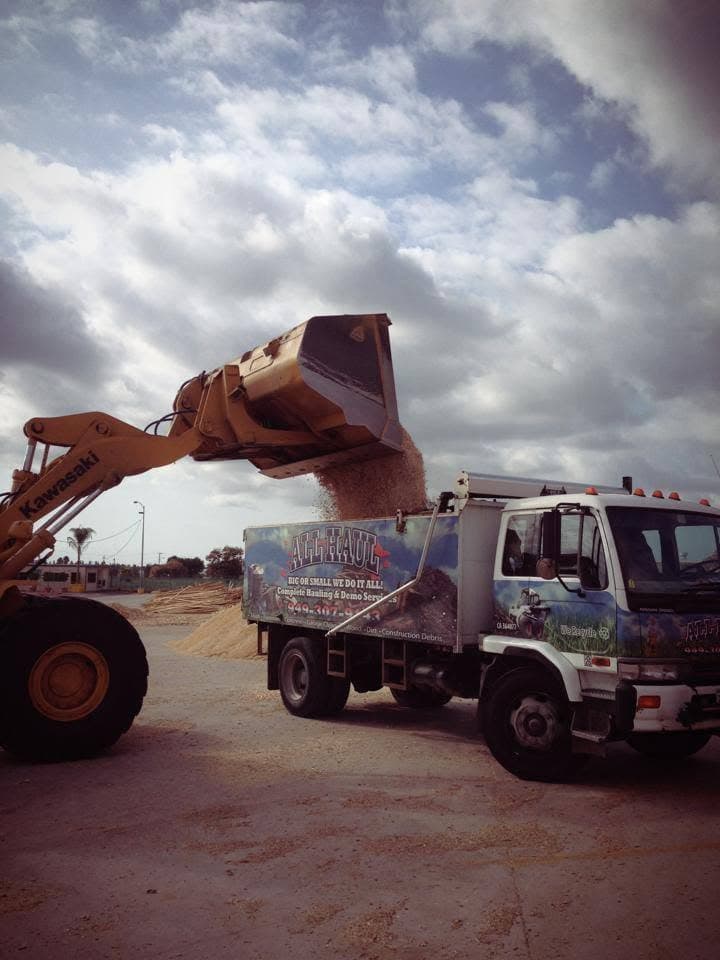 Excavator loading debris into the All Haul truck