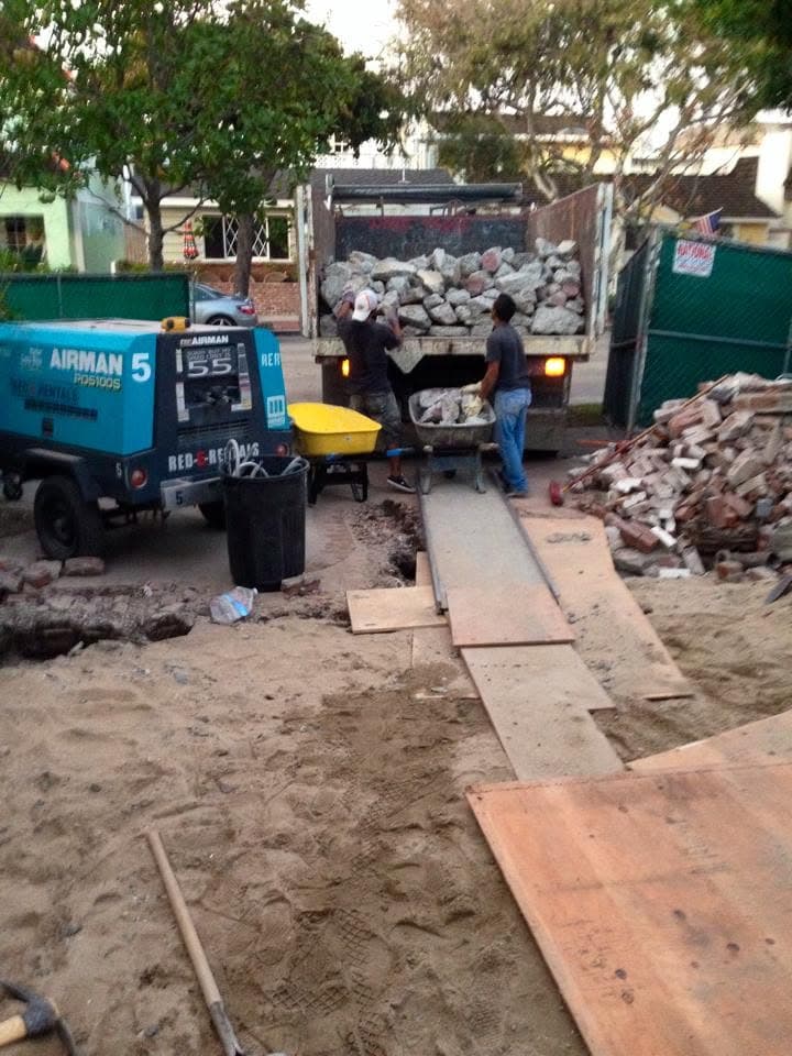 Crew loading broken concrete and rubble into the truck