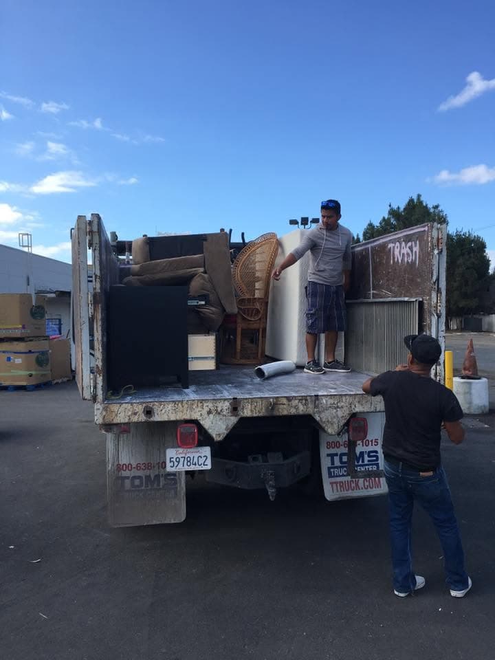 Crew loading furniture into the truck bed