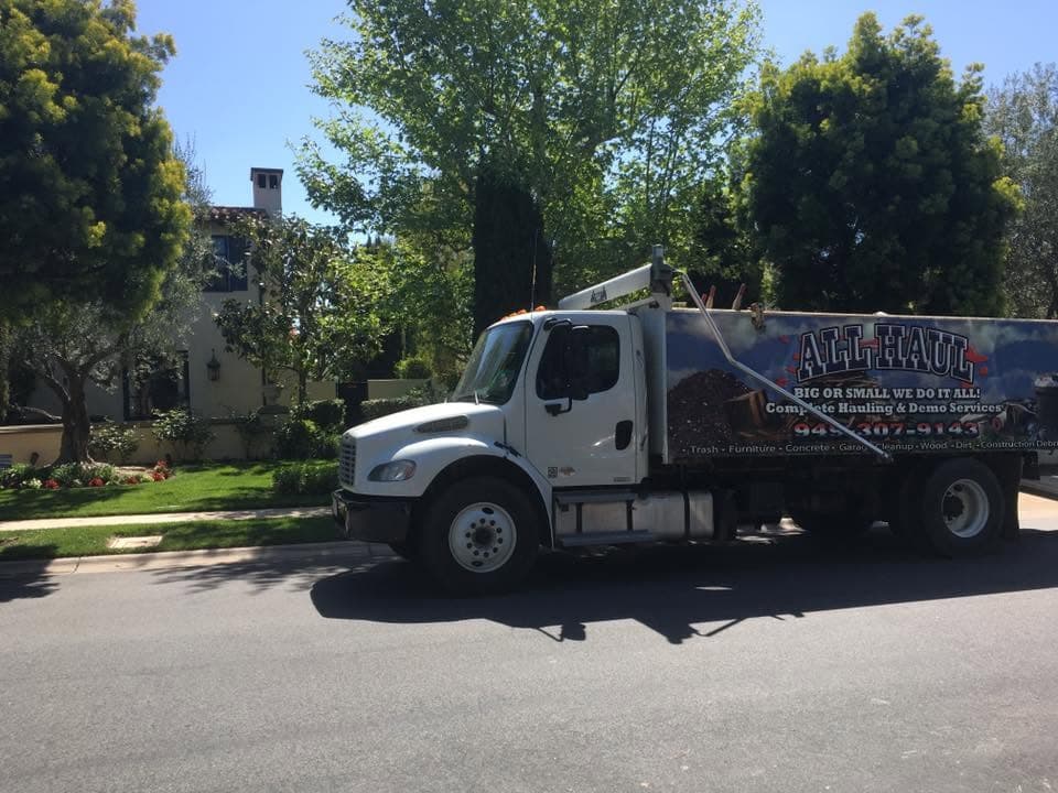 All Haul truck parked outside a home in an upscale neighborhood