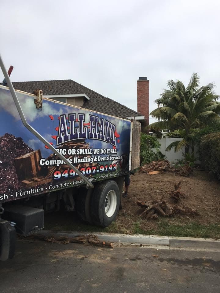All Haul truck removing a tree stump and yard debris