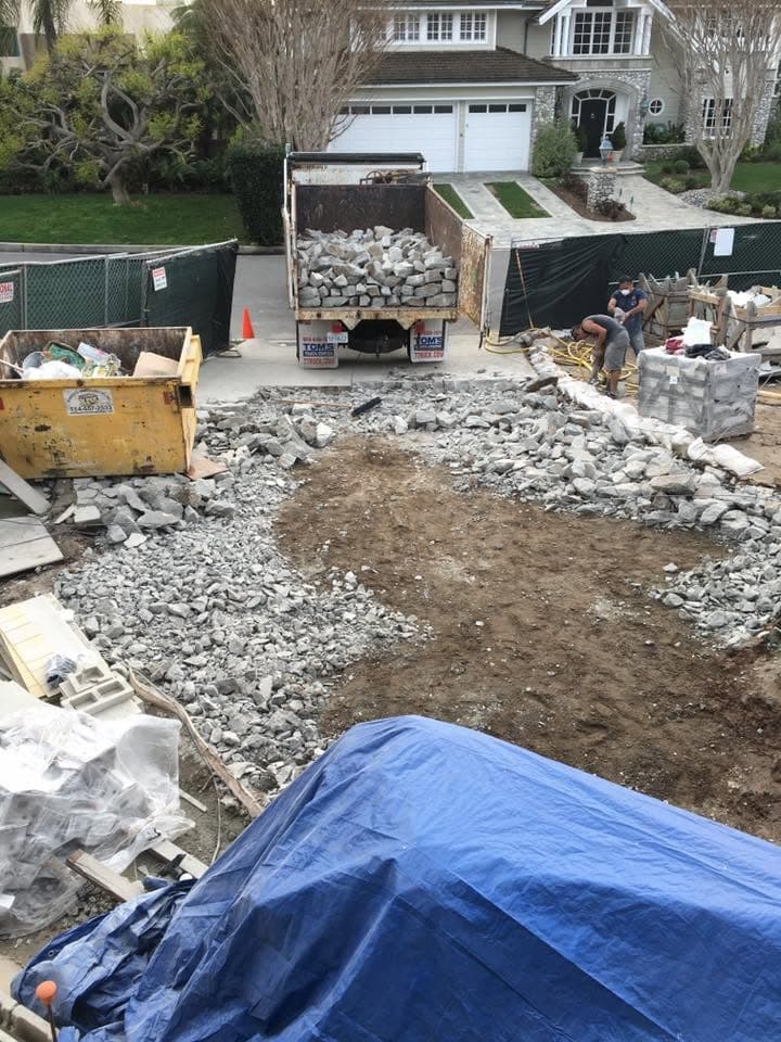 Aerial view of a concrete demolition job with the loaded truck