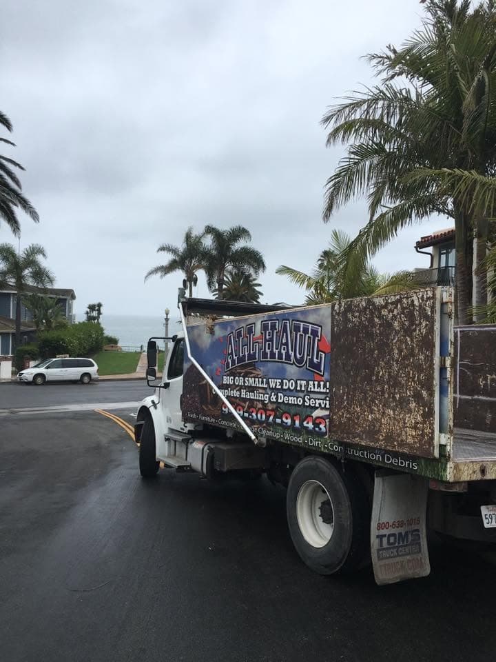 All Haul truck parked on a coastal street under cloudy skies