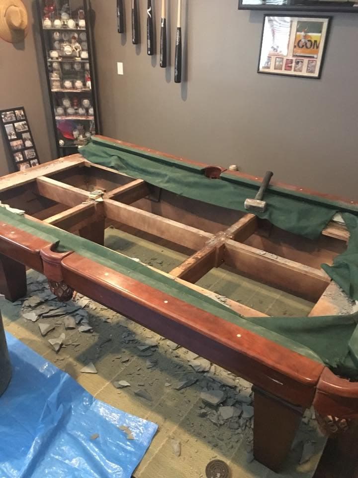 Pool table being disassembled for removal
