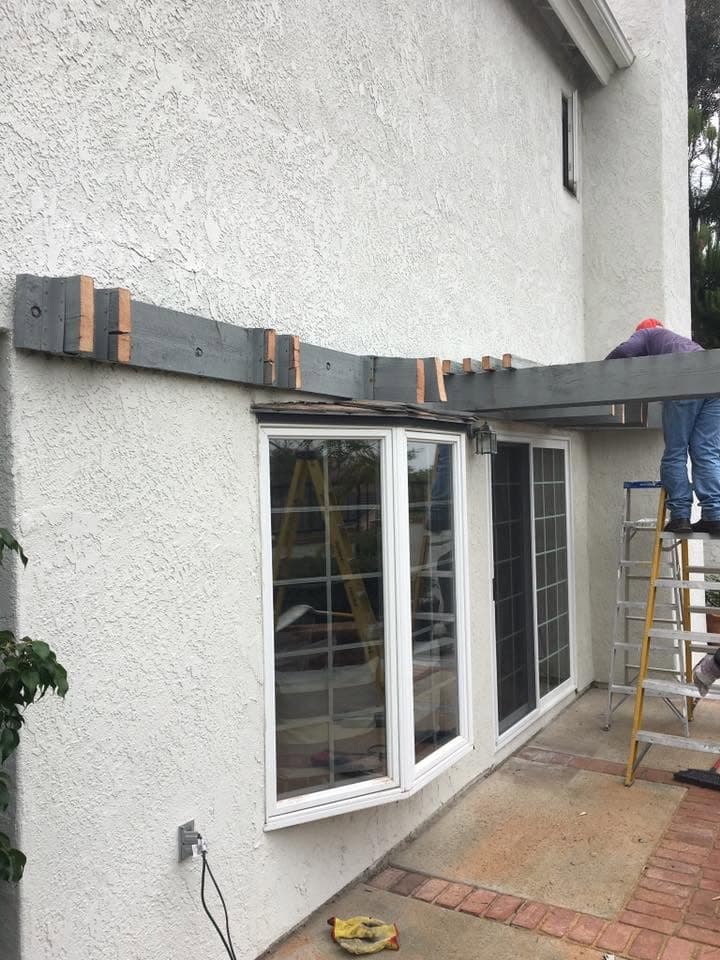 Crew removing a patio cover beam