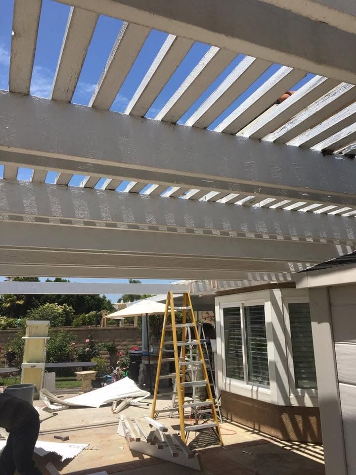 Patio cover mid-removal, debris on the ground