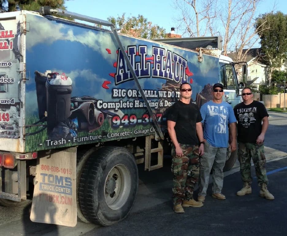 The All Haul Inc. crew standing in front of the company truck